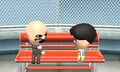 Two Miis chatting on a bench.